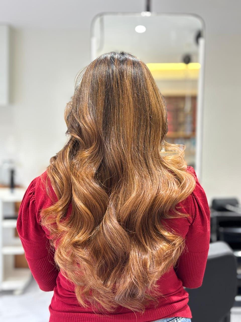 Back view of dimensional caramel and honey balayage waves crafted at TRÈS BON Salon